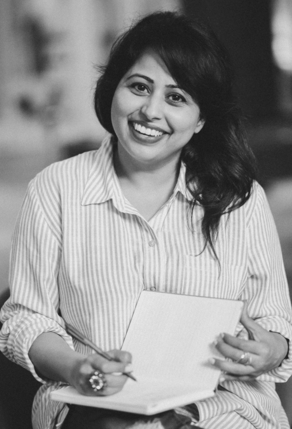 Deepika Kaushik writing and smiling